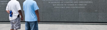 a father and son in front of the Martin Luther King Jr. Memorial in Washington, DC