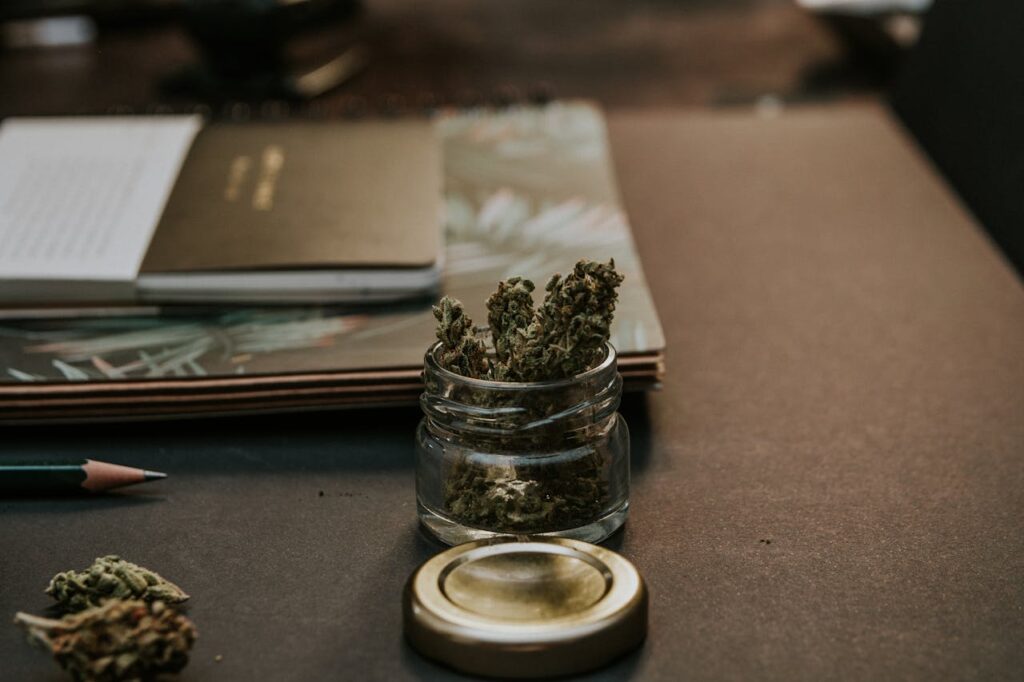 nugs in a glass jar on desk, papers and pen