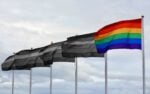 five pride flags in a row, four are black and white