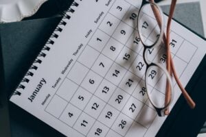 calendar with glasses sitting on top