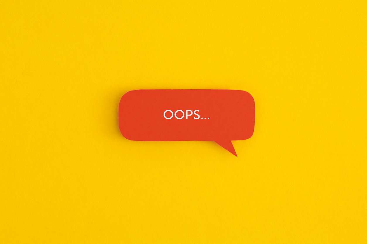 Paper speech bubble with the word "OOPS" on a yellow background.