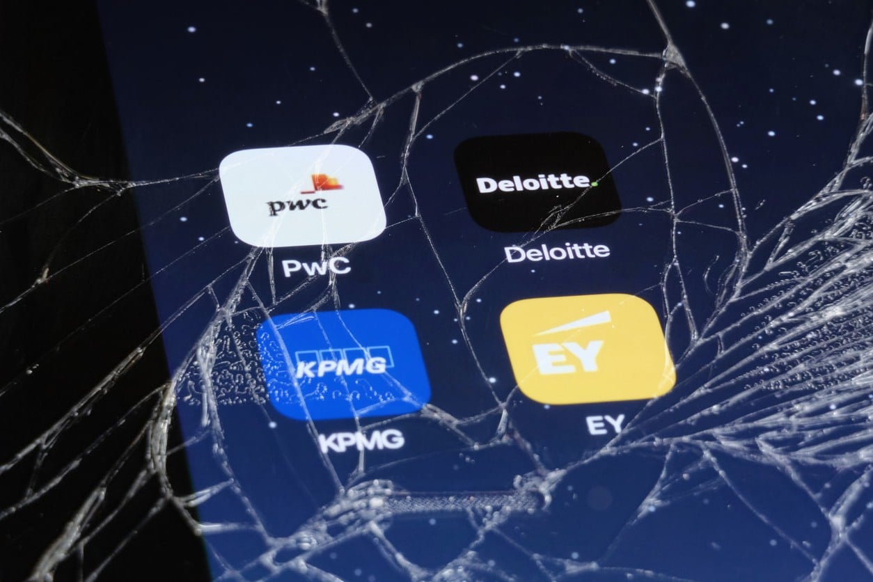 Big 4 accounting firm app logos on cracked phone screen