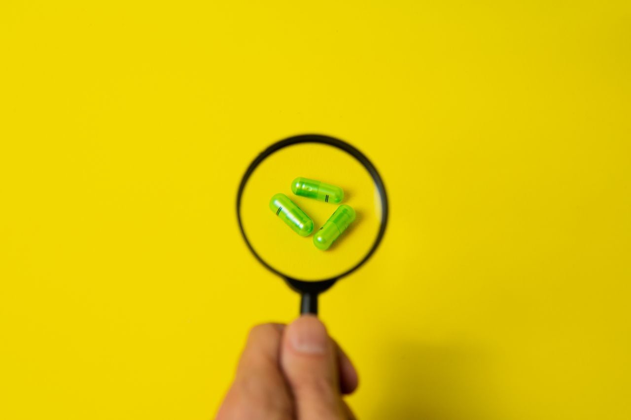 drugs under magnifying glass, drug audit