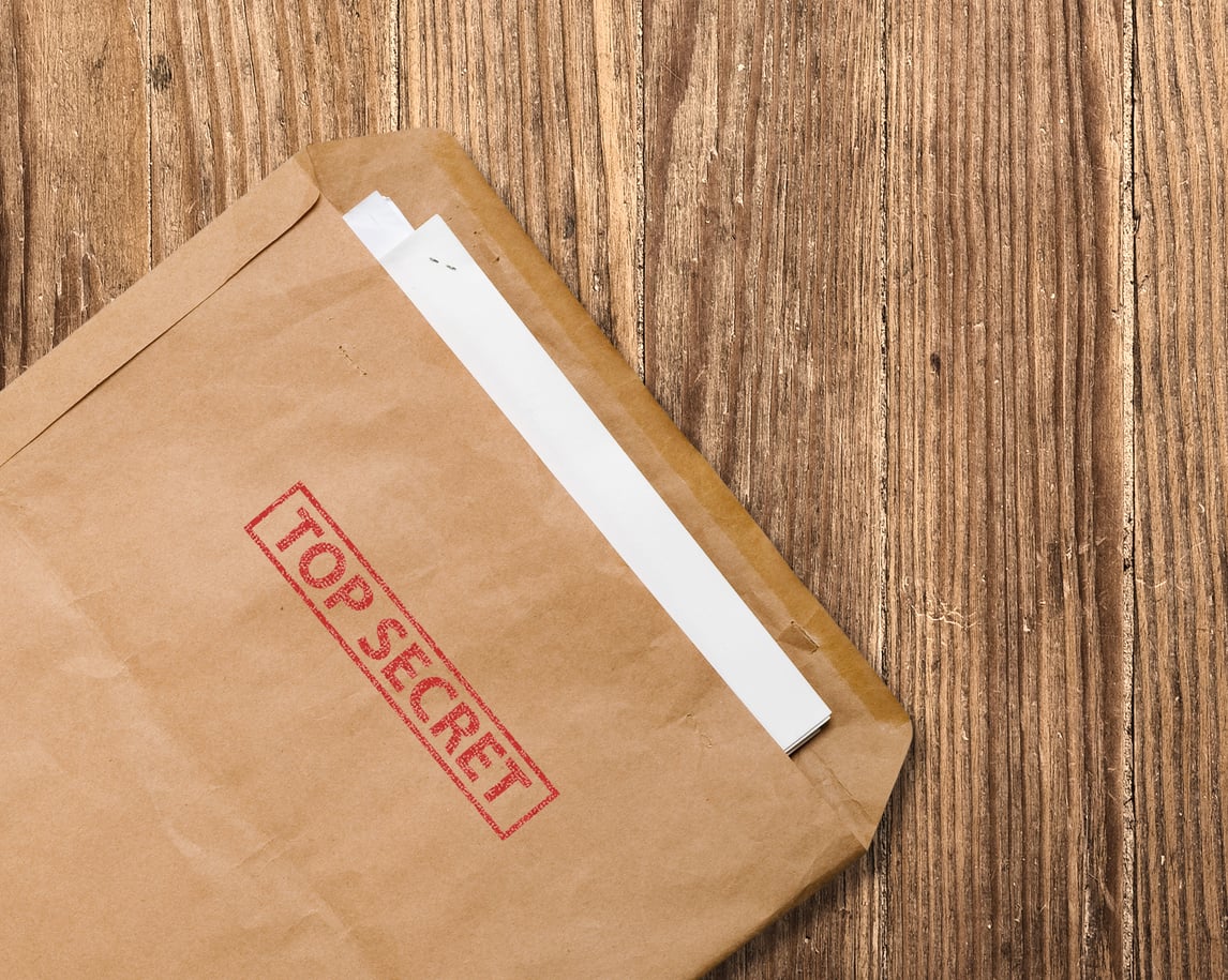 Open top secret envelope on a table